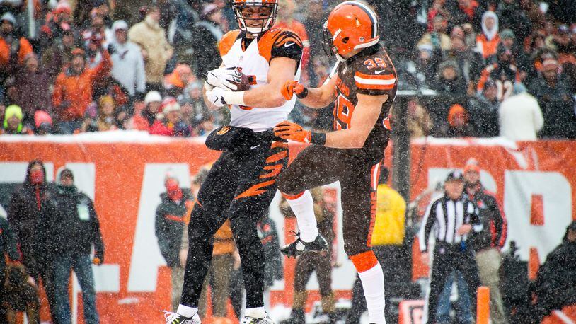 Bengals tight end Tyler Eifert catches a touchdown pass while under pressure from Browns free safety Ed Reynolds  during a game on December 11, 2016 in Cleveland's FirstEnergy Stadium.
