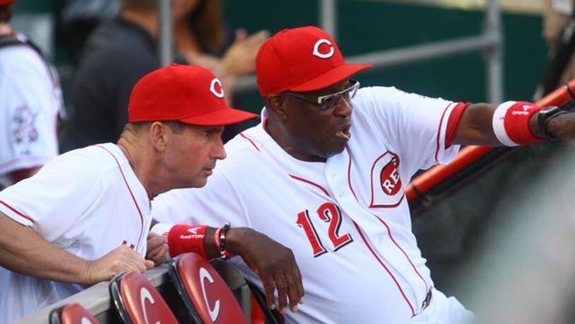 Third-base coach Mark Berry and manager Dusty Baker talk before the game. The Reds beat the Padres 7-2 on Friday, Aug. 9, 2013, at Great American Ball Park in Cincinnati.