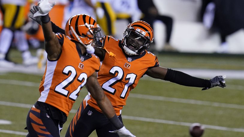 Cincinnati Bengals' Mackensie Alexander (21) and William Jackson (22) celebrate after Pittsburgh Steelers turned the ball over on downs during the second half of an NFL football game, Monday, Dec. 21, 2020, in Cincinnati. (AP Photo/Michael Conroy)