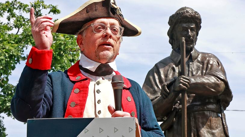 Jeff Hansell, a descendant of Springfield founder James Demint, speaks following the unveiling of a statue of his ancestor during a dedication ceremony for the renovated Springfield Burying Ground in downtown Springfield Saturday, May 27, 2023. BILL LACKEY/STAFF