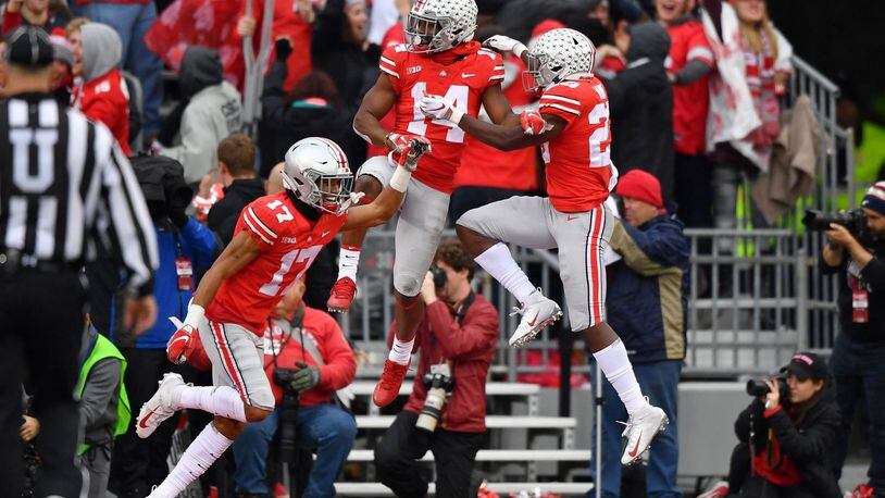 Chris Olave #17, K.J. Hill #14 and Jahsen Wint #23 of the Ohio State Buckeyes, celebrate after Olave blocked a Michigan Wolverines punt in the third quarter and Ohio State scored a touchdown at Ohio Stadium on November 24, 2018 in Columbus, Ohio. Ohio State defeated Michigan 62-39. (Photo by Jamie Sabau/Getty Images)