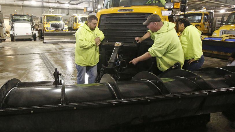 City of Dayton workers prepared their trucks on Thursday for the winter storm that is expected to start as rain and freezing rain on Friday and turn into snow overnight into Saturday. TY GREENLEES / STAFF