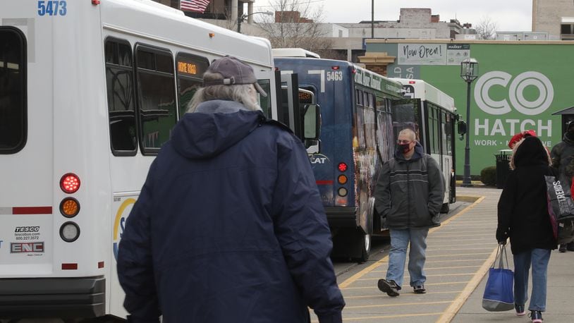 Riders get on and off the SCAT buses last year at the bus center in downtown Springfield. BILL LACKEY/STAFF
