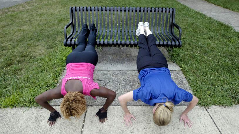Jackie Brockman, associate executive director of the Trotwood YMCA, helps train Nashanda Peeples on exercises that can be performed in just about any urban environment. The urban landscape, from parks and playgrounds to stadium steps or bleachers, can provide opportunities for cardiovascular and muscle-conditioning workouts. You can do push-ups on a park bench. A parking lot and its concrete pylons can provide both interval training and muscle conditioning.