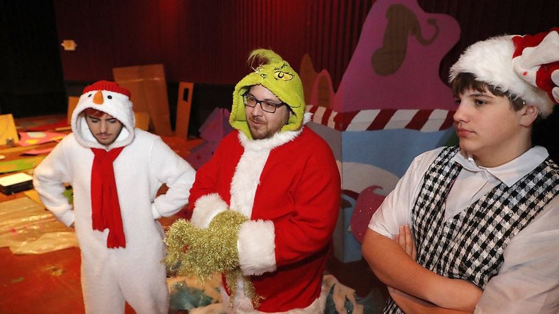 Noah Council, left, Lucas Keeran, center, Jaison Council dressed up their Grinch costumes at the Upper Valley Mall Cinema Friday to talk about the Breakfest with the Grinch fundraiser that will be held Dec. 2 in a recreated Whoville in the cinema. Bill Lackey/Staff