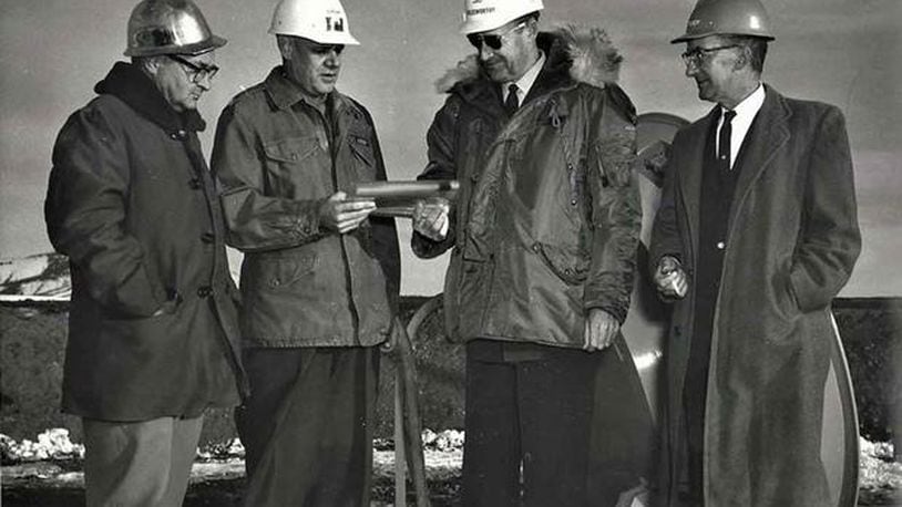 In a Nov. 1961 ceremony at Malmstrom Air Force Base, then-Colonel Harry Goldsworthy, accepts a symbol of the first completed Minuteman operational silo from Army Area Engineer Colonel Arthur H. Lahlum. U.S. Air Force photo