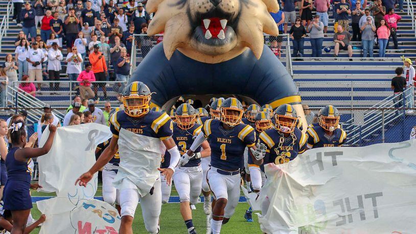 The Springfield High School football team runs onto the field for its Week 1 game against Lancaster at Evans Stadium earlier this season. The Wildcats face Hilliard Davidson in a Division I, Region 3 semifinal game at 7 p.m. Friday at London High School. CONTRIBUTED PHOTO BY MICHAEL COOPER