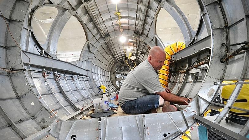 Duane Jones, a member of the restoration team for the National Museum of the U.S. Air Force Force, works inside the "Swoose," a Boeing B-17 D. The Swoose is the only existing Boeing B-17 D, museum curators say. MARSHALL GORBY \STAFF