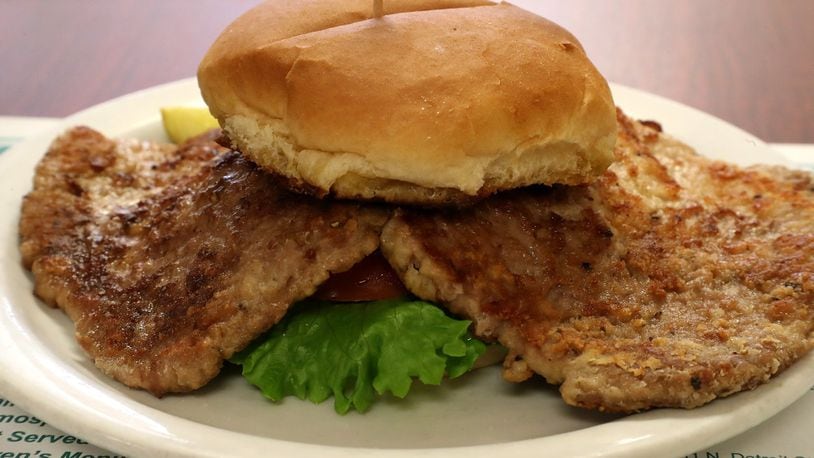 The Country Fried Tenderloin Sandwich at the Liberty Gathering Place overflows the bun. BILL LACKEY/STAFF