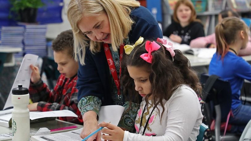 Lotus Smith, English and Science teacher at Lagonda Elementary School in the Springfield City School District, instructs a student during class time in 2020. BILL LACKEY/STAFF