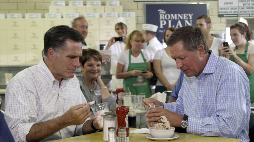 In this Aug. 14, 2012 photo, former Massachusetts Gov. Mitt Romney and Ohio Gov. John Kasich at Tom’s Ice Cream Bowl in Zanesville during the 2012 presidential election. (AP Photo/Mary Altaffer, File)
