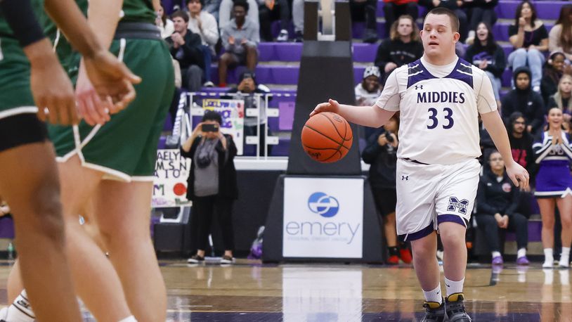 Middletown High School senior Luke Atkinson, who has Down syndrome, has served as boys basketball team member for four years. On Tuesday night, the last home game of the season at Wade E. Miller Gym, he started for the Middies and scored two points against Mason. NICK GRAHAM/STAFF