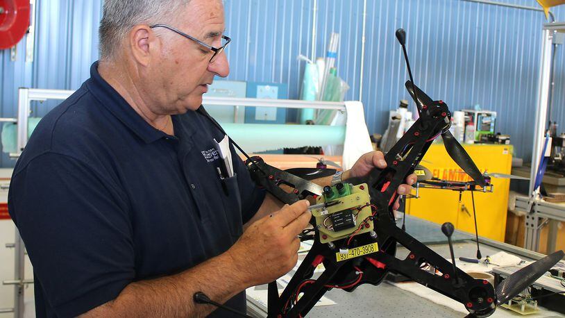 Frank Beafore, owner of SelectTech, works on a UAV Friday. Clark State adds to its ag precision program. Jeff Guerini/Staff