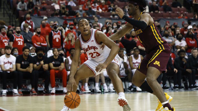 Ohio State's Zed Key, left, looks for an open pass as Minnesota's Eric Curry defends during the second half of an NCAA college basketball game Tuesday, Feb. 15, 2022, in Columbus, Ohio. (AP Photo/Jay LaPrete)